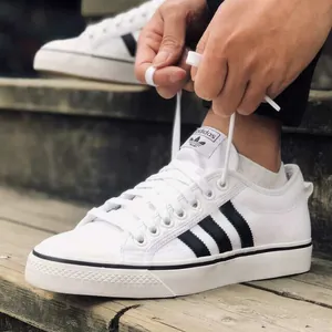Adidas Nizza RF Sneaker in white canvas worn on feet with invisible socks.jpg